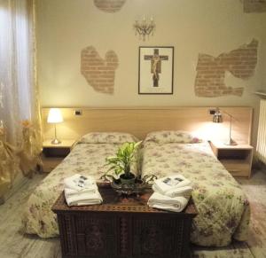 a bedroom with a bed with towels on a table at La Casa del Viandante in Modena