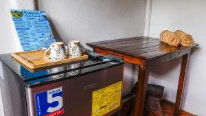 a table on top of a refrigerator with a table on top at Rio Celeste Cabinas Vista Tenorio in El pilon