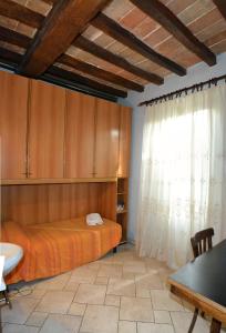 a bedroom with a bed and wooden cabinets and a window at La Casa del Viandante in Modena