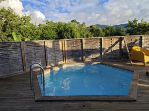 a hot tub on the deck of a house at Bungalow Villa-Déhé in Deshaies