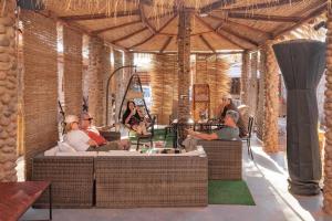 a group of people sitting inside of a building at Hostal Katarpe in San Pedro de Atacama
