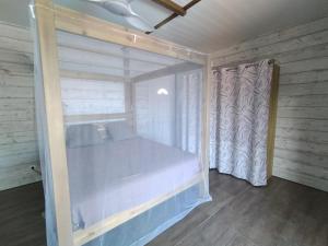 a room with a large window and a curtain at Ambre et Azur 2 in Sainte-Rose