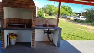a outdoor kitchen with a sink and a window at ItuRanch II in Ituzaingó