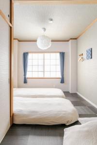 名古屋市にあるDomus OZONEの窓のある部屋にベッドが2つある