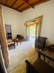 a living room with a couch and a table at Fine Homes in Kalutara