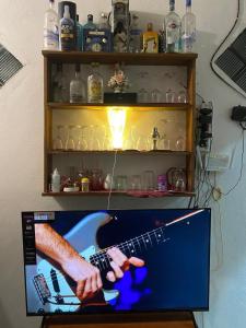 a computer monitor with a picture of a guitar on it at Villa Sun Rising in Talpe