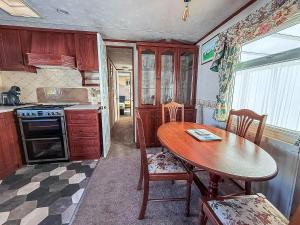 A kitchen or kitchenette at Lovely Caravan With Large Decking At Southview Holiday Park Ref 33108S