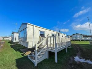 a mobile home with a porch and a staircase at Lovely 8 Berth Caravan At Manor Park Nearby Hunstanton Beach 23107S in Hunstanton