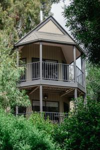 a large house with a balcony on the side of it at Acacia at Boardwalk Villas in Metung