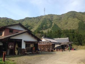 a group of buildings with a mountain in the background at Guest House Warabi in Mino