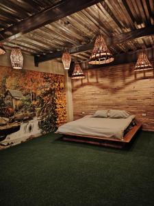 a bedroom with a large bed and chandeliers at Camping con jacuzzi en la ciudad in San Baltasar