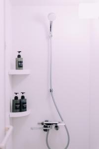 a shower in a bathroom with two shelves at Minimalist Loft 5 Namba Compact Studio and Gym MA503 in Osaka +41 photos