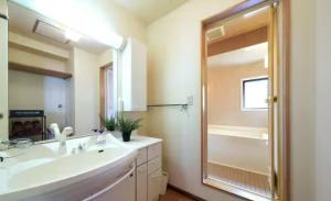 a bathroom with a sink and a shower and a mirror at おやど紀伊国屋銀屋町 in Nagasaki +36 photos