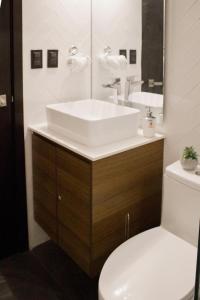 a bathroom with a white sink and a toilet at Villa City, Ciudad de Guatemala, EON zona 10 in Estación Pamplona