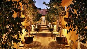 a courtyard with chairs and trees in a building at Beso Del Sol in Huntington Beach
