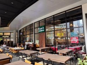 a restaurant with tables and chairs in a building at The Air Residences #3724 in Manila