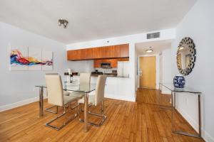 a kitchen and dining room with a table and chairs at 1Bd Apt with Free Parking and Amazing View in Miami