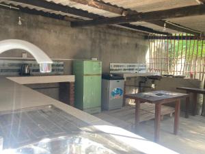 a kitchen with a stove and a table in it at Banana Leaf Garden in Weligama