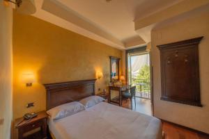 Ένα ή περισσότερα κρεβάτια σε δωμάτιο στο Hotel Teocrito