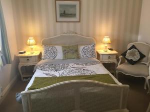 A bed or beds in a room at Copperfields Guest House 