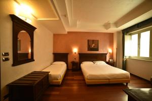 Ένα ή περισσότερα κρεβάτια σε δωμάτιο στο Hotel Teocrito