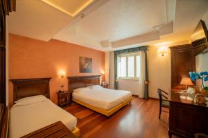 Ένα ή περισσότερα κρεβάτια σε δωμάτιο στο Hotel Teocrito