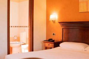 Ένα ή περισσότερα κρεβάτια σε δωμάτιο στο Hotel Teocrito
