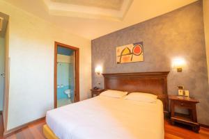 Ένα ή περισσότερα κρεβάτια σε δωμάτιο στο Hotel Teocrito