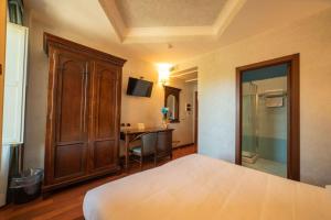 Ένα ή περισσότερα κρεβάτια σε δωμάτιο στο Hotel Teocrito