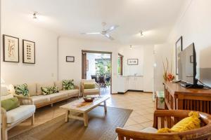 a living room with a couch and a table at Hibiscus POOL VIEW Villa 49b in Port Douglas