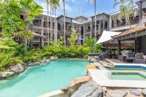 an image of a swimming pool in front of a building at Hibiscus POOL VIEW Villa 49b in Port Douglas +7 photos