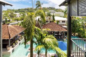 a view of the pool from the balcony of a resort at Hibiscus POOL VIEW Villa 49b in Port Douglas