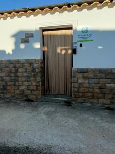 a wooden door on the side of a building at Casa De Aventuras ideal for large groups in Bácor +37 photos