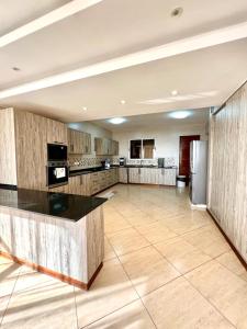 a large kitchen with a large island in the middle at Antalyia Luxury Apartments Nyali in Mombasa
