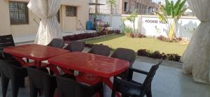 a red table and chairs in a room with a yard at Kookee Villa in Hātgarh