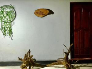 a wall with a sign that says enjoy the wildlife at Hena Villas Campsite in Kataragama