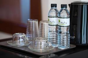- un plateau avec 2 bouteilles d'eau et des verres dans l'établissement Apartments Near Bangtao Muay Thai & MMA, à Ban Thalat Choeng Thale