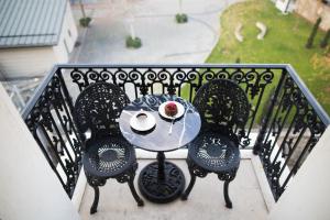 a table on a balcony with a plate of food on it at Maroon Hotel Pera in Istanbul