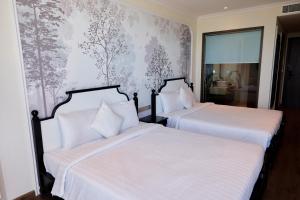 Ein Bett oder Betten in einem Zimmer der Unterkunft The Apec Mandala Ocean View Mui Ne - Condotel