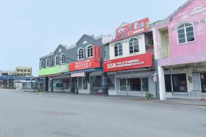 a row of buildings on a city street at Song 99 Hotel in Simpang Renggam