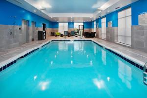 a large swimming pool with blue water at Hampton Inn & Suites By Hilton Indianapolis South Greenwood in Indianapolis