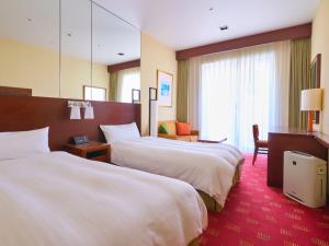Postel nebo postele na pokoji v ubytování Miyako Hotel Kyoto Hachijo