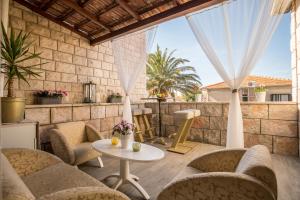 a patio with chairs and a table on a patio at Apartments Marija in Supetar