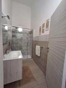a white bathroom with a shower and a sink at Casa Carruvedda in Avola +24 photos
