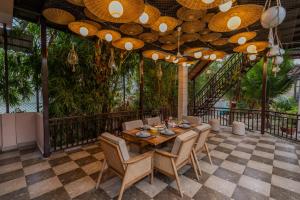 a dining room with a table and chairs at SaffronStays Casa Octavia in Bhīm Tāl
