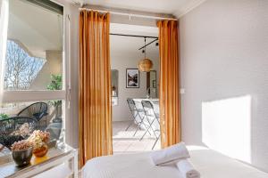 a bedroom with an open door to a patio at The Lake Aurora Suite - Duke Housing in Créteil