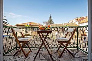 a table with a bowl of fruit on a balcony at Apartments Marija in Supetar
