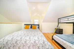 a bedroom with a bed with orange pillows at Stunning 3BR Quincy Home w Laundry, Bathtub, near Red Line & Adams NHP 39 in Quincy