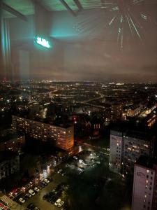 a view of a city at night with fireworks at Hanza Tower Apartment - 22 floor, swimming pool & SPA in Szczecin