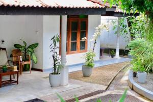 a courtyard of a house with potted plants at The Golden Sand Villa in Unawatuna in Unawatuna
